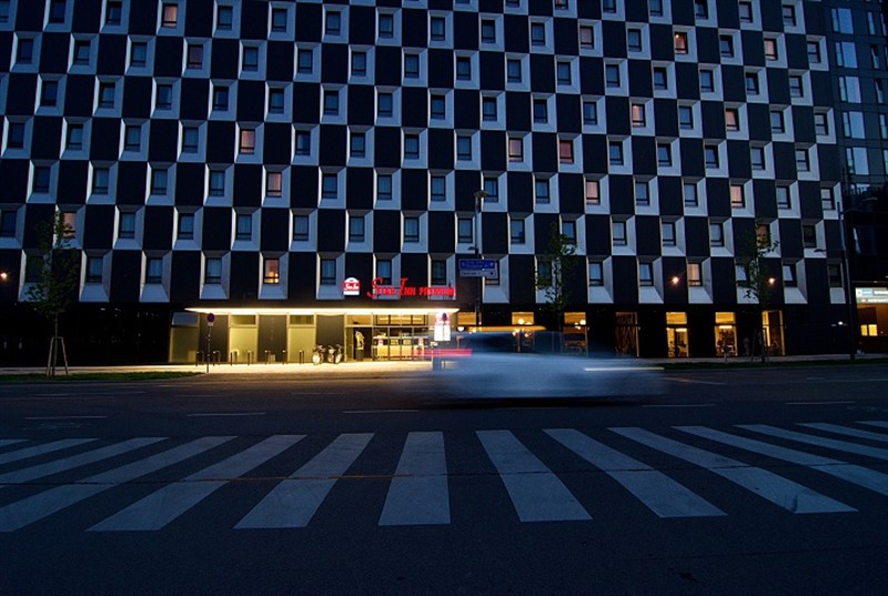 Záběr na Star Inn hotel, kde zajímavě (z hlediska fotografie) ladí pruhy na přechodu s okny hotelu